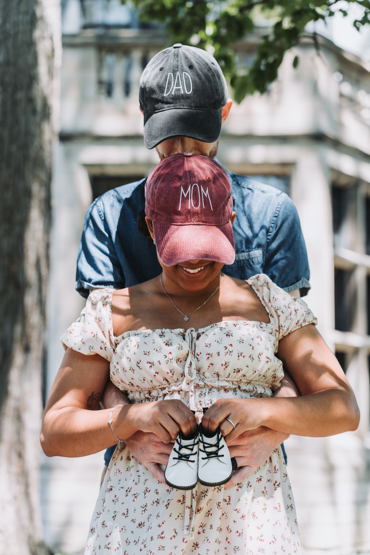 Mom & Dad holding tiny baby shoes
